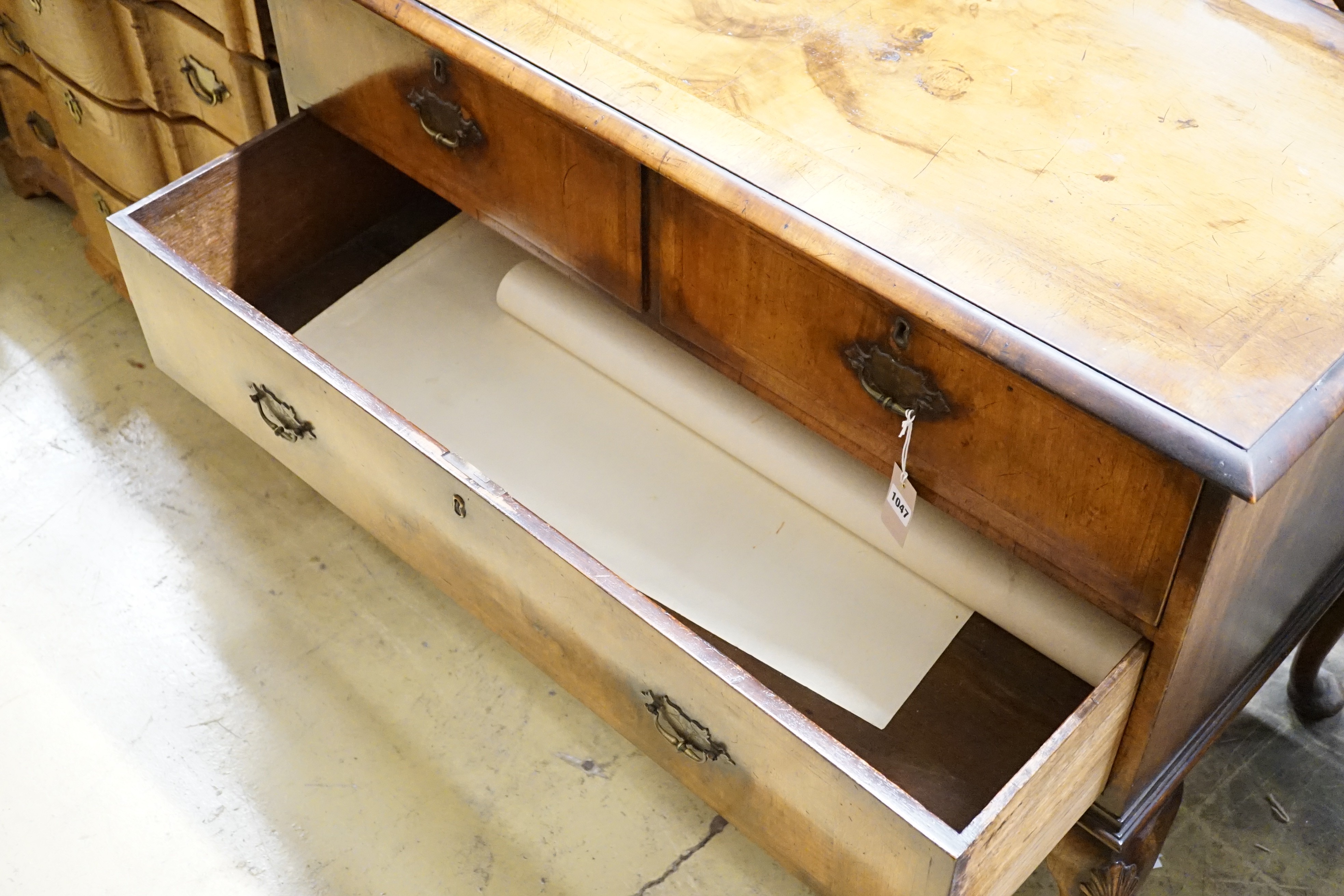 A Queen Anne style walnut chest of three drawers on cabriole legs, width 111cm, depth 56cm, height 83cm